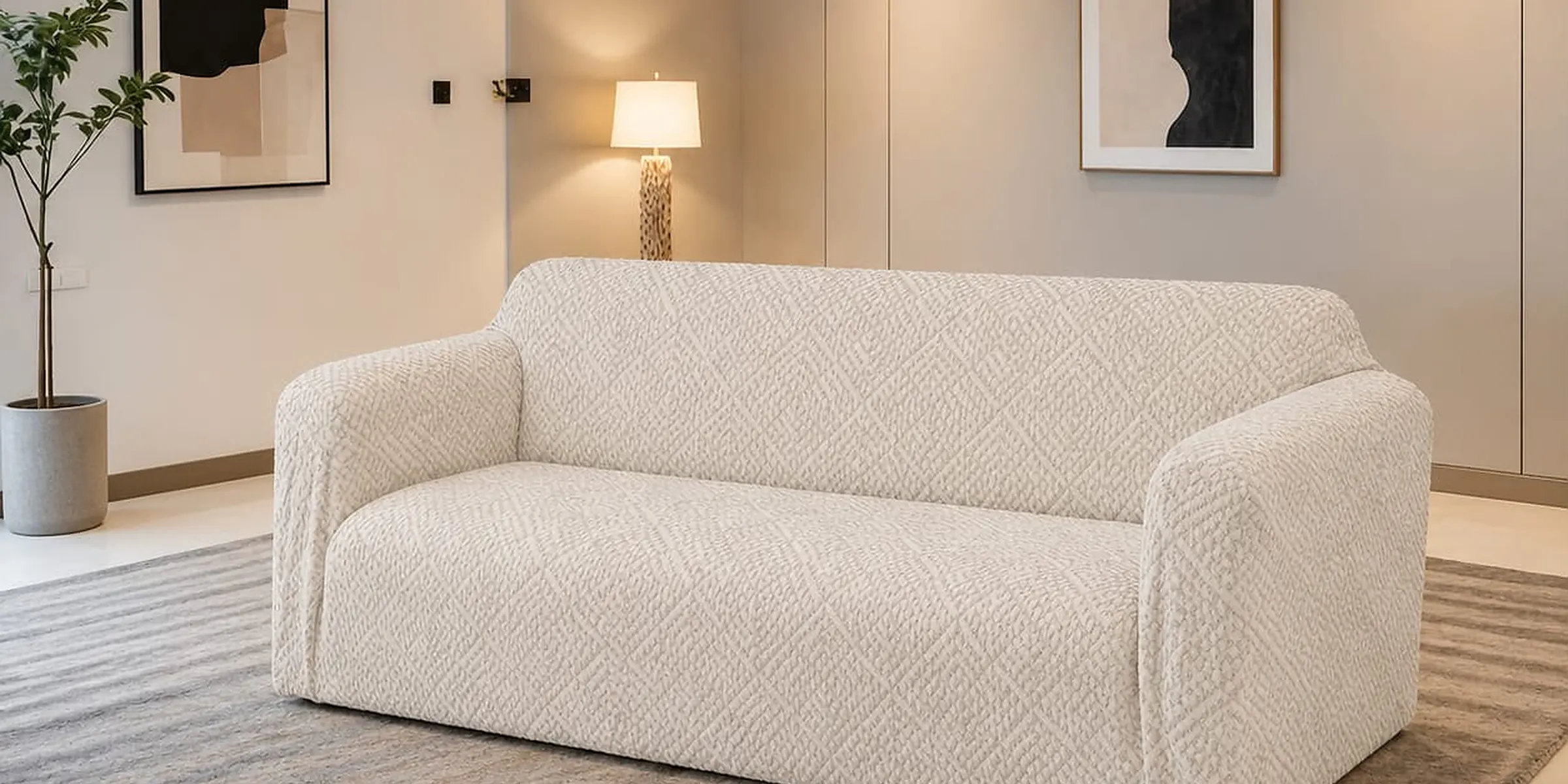 Ivory textured slipcover on a three-seat sofa in a bright living room